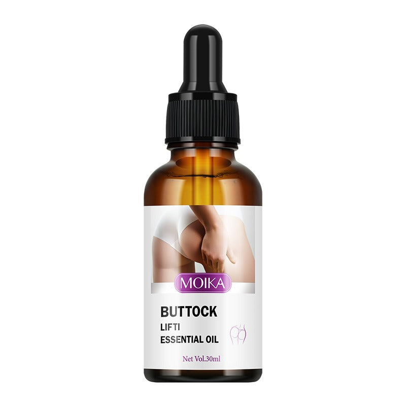 An amber glass dropper bottle of MOIKA Buttock Lift Essential Oil with a black dropper cap and a white label featuring a photo of a buttock.
